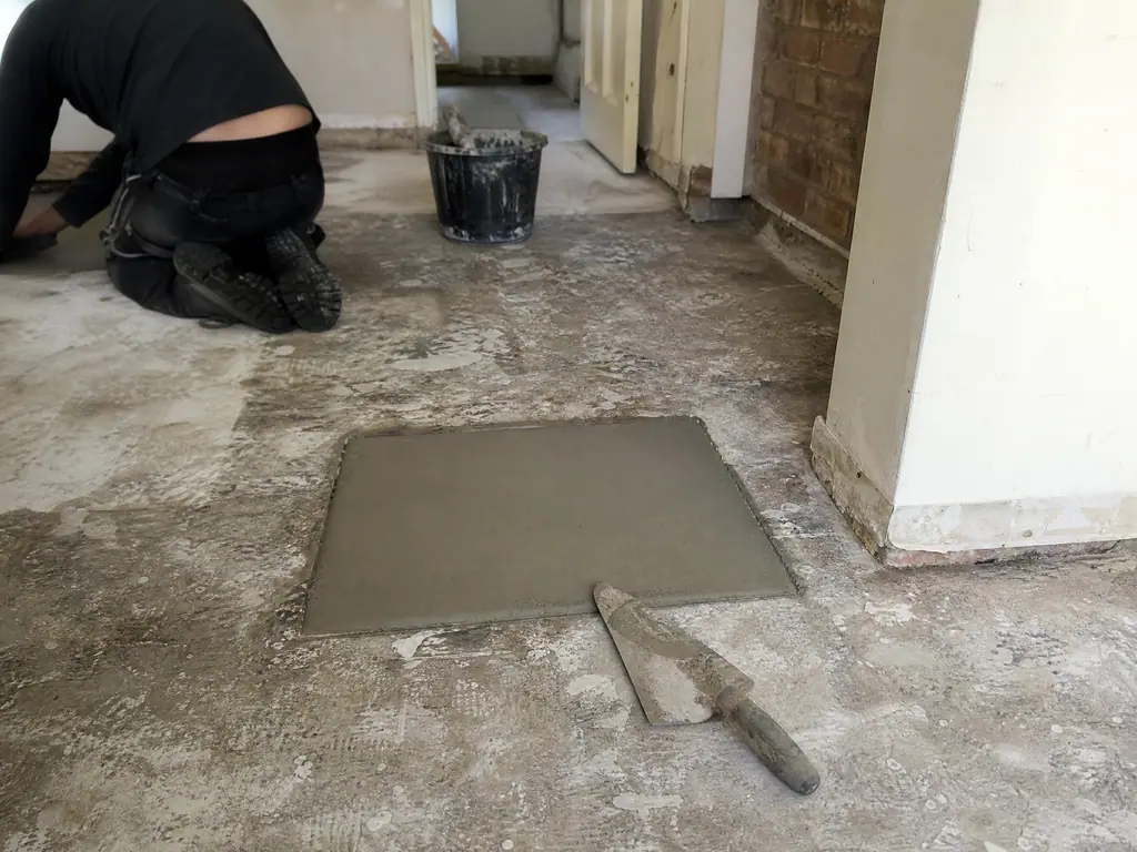 Floor section made good with new screed after a leak was repaired, Nottingham