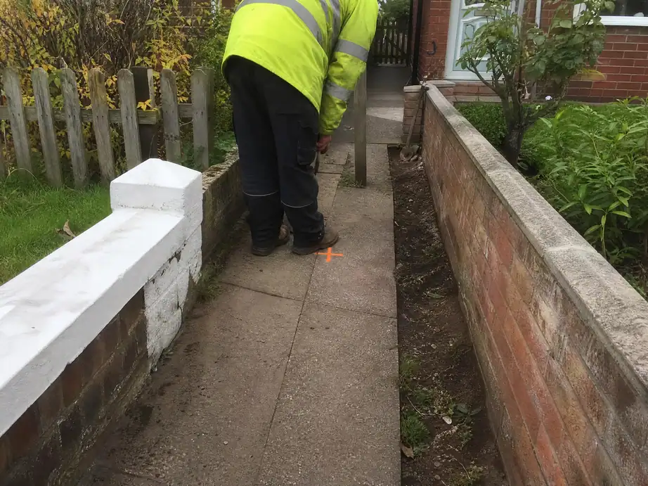 Leak position marked on a path between two neighbouring gardens, Nottingham