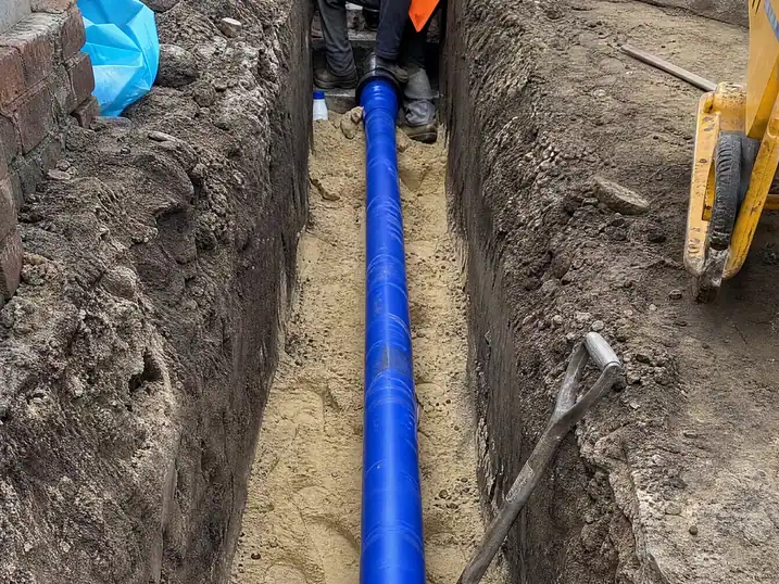 New water supply pipe bedded in sand at the bottom of a trench, Nottingham