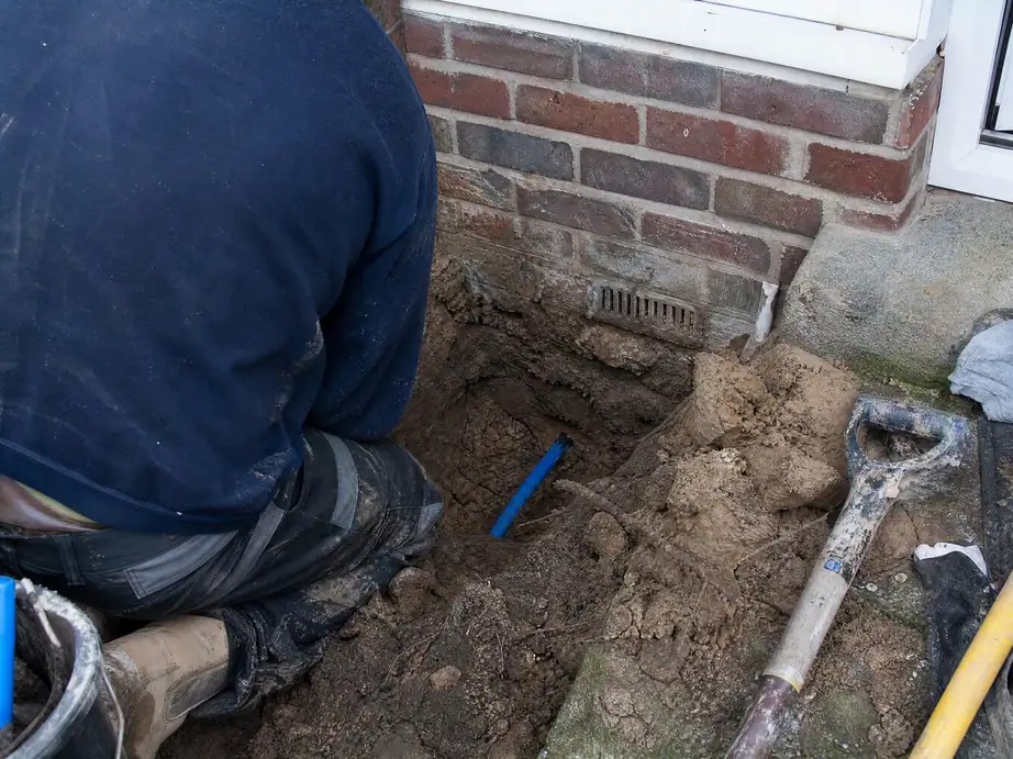 Receiving pit beside a house wall with the new moled water pipe coming through, Nottingham